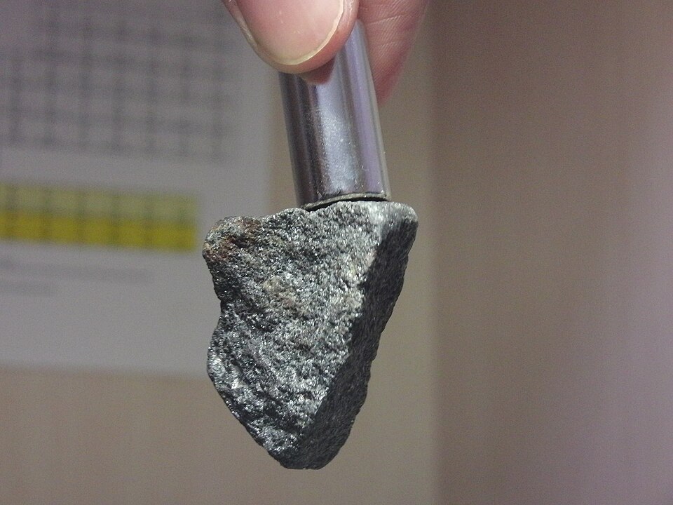 How Magnets Work: Four Quantum Requirements 1 How magnets work - A magnetite rock is being pulled by a neodymium magnet on top.